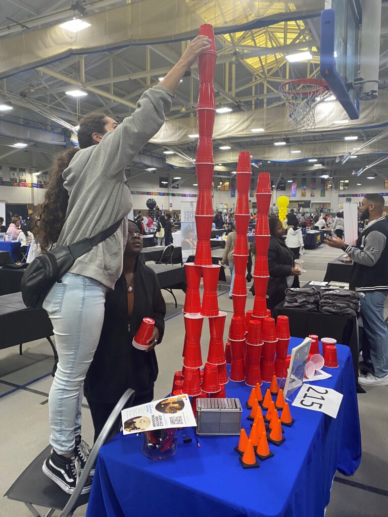 Students Stacking Cups Higher